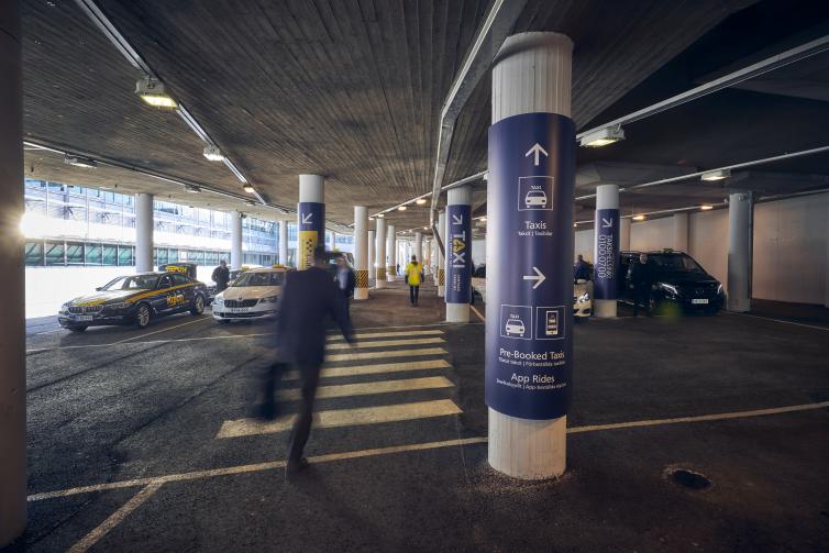 Passenger walking towards taxi rank.