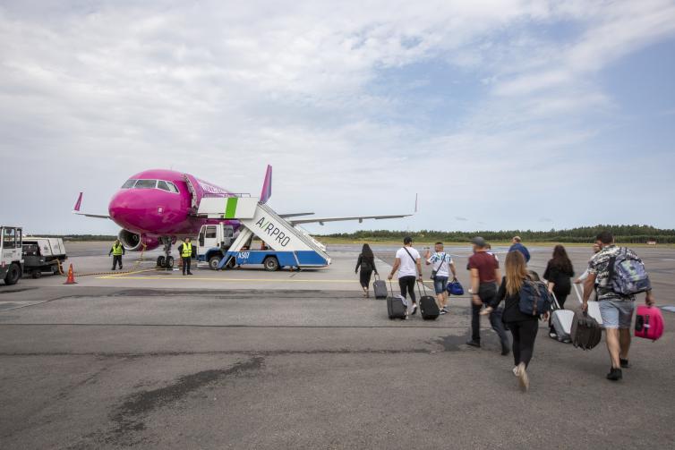 Passengers boarding Wizz Air's airplane.