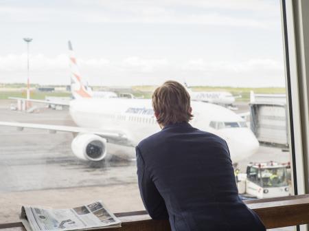 Businessman watching airplanes