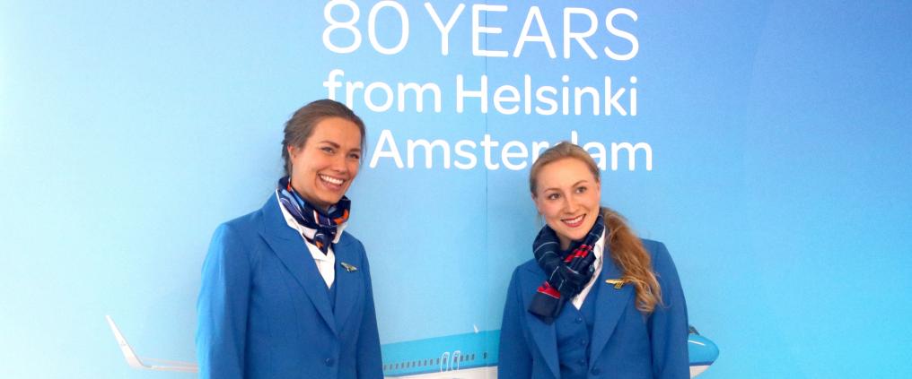 KLM airline staff posing for pictures at KLM 80 years celebration event.