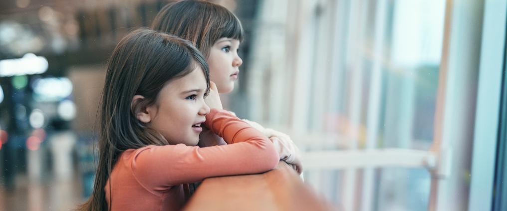 Little girls watching plains at Helsinki Airport.