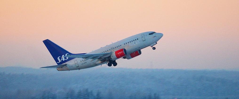 Scandinavian Airlines airplane taking off.